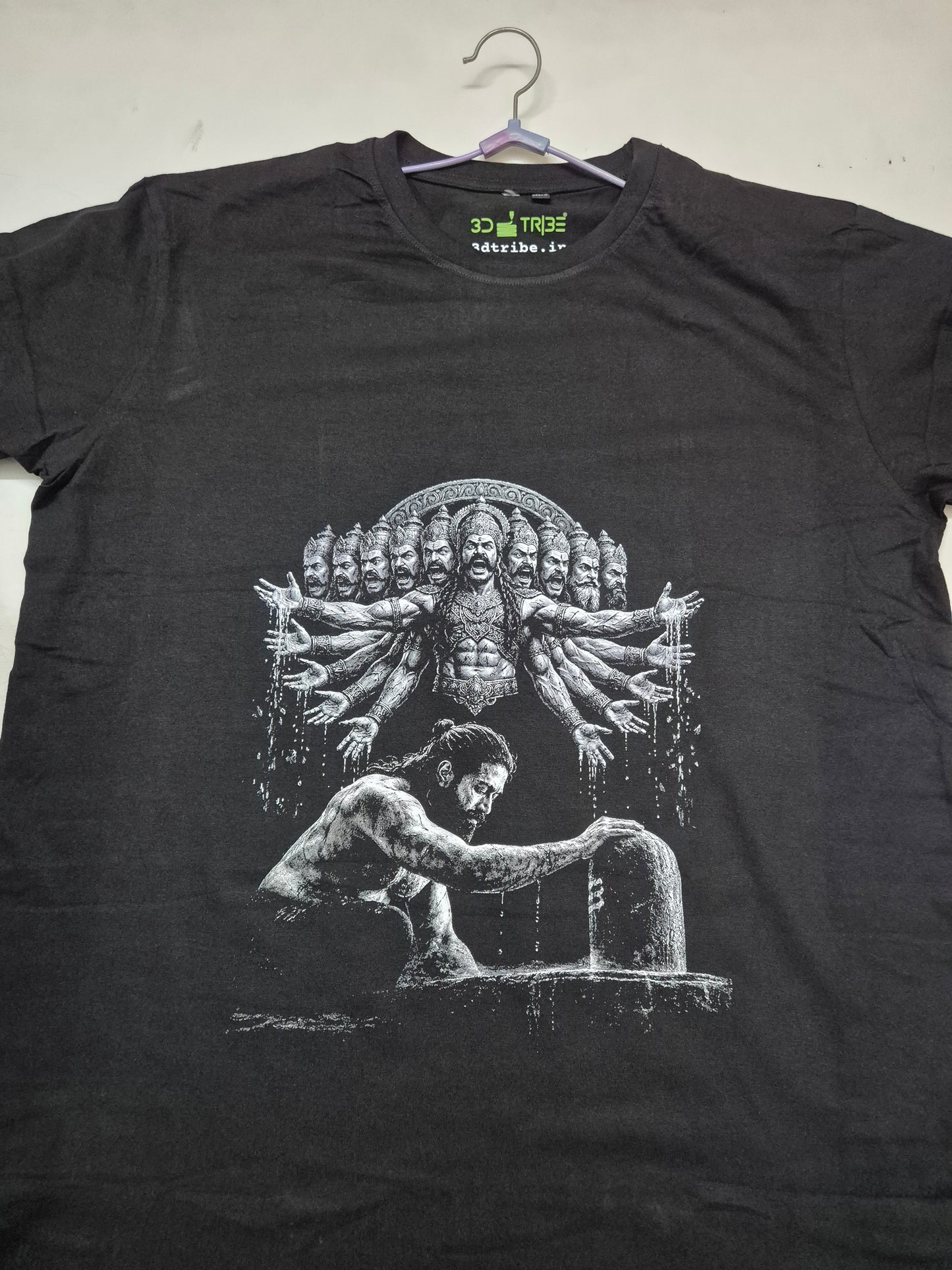 Black t-shirt with white graphic design on a hanger against a white background