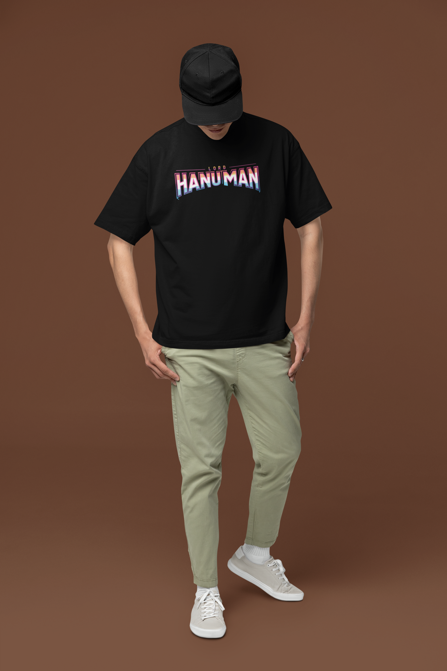 Person wearing a black t-shirt with 'HANUMAN' printed on it against a brown background